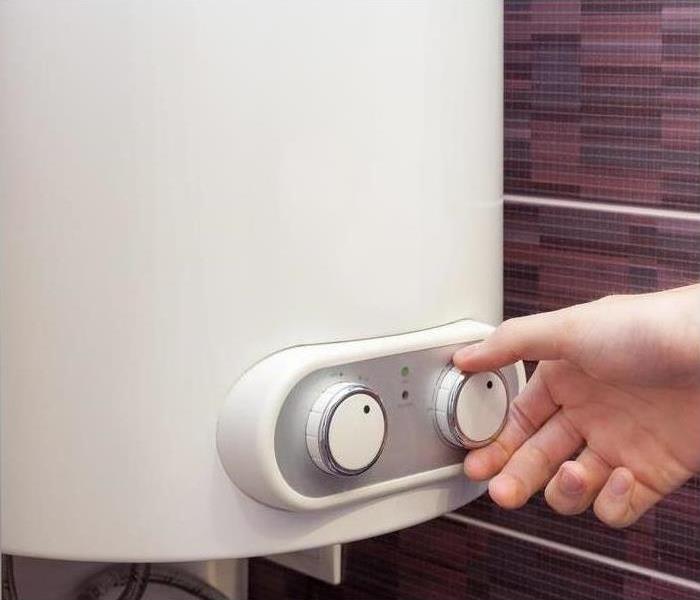 Adjusting the dials on a water heater
