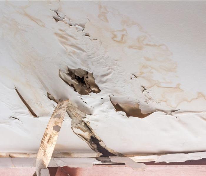 damaged drywall ceiling with water stains