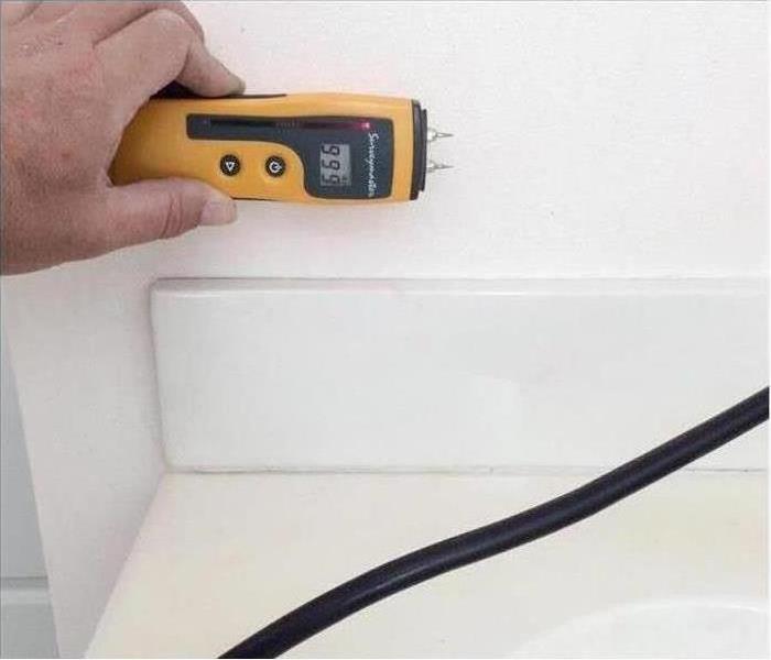 Moisture Meter being used on drywall to verify the walls are moisture free
